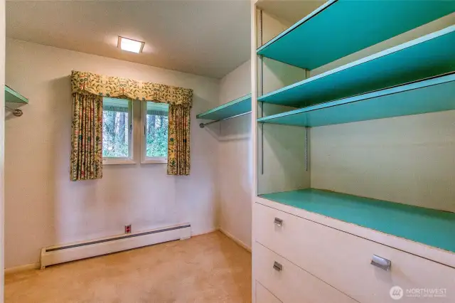 The second primary ensuite bedroom has another walk-through closet to a full bathroom.