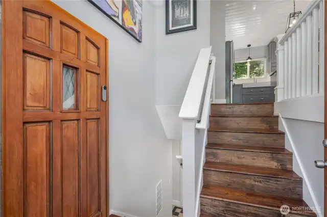 Foyer leads to wood floors & open staircase