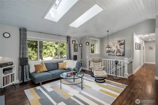 Great room with vaulted shiplap ceilings & skylights
