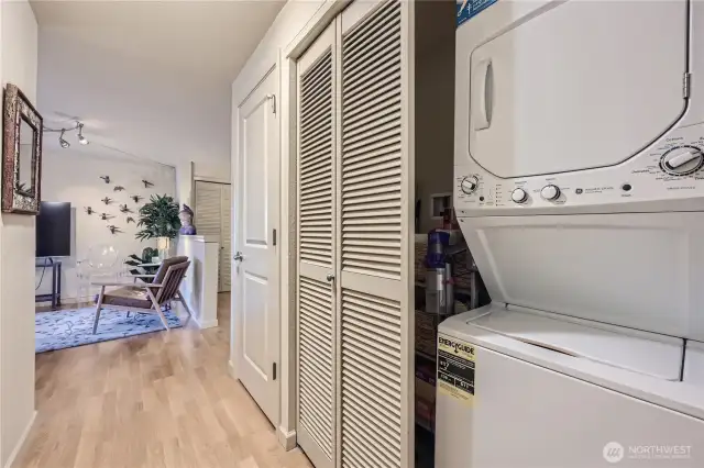 Hallway to primary bedrooom, more storage and w/d