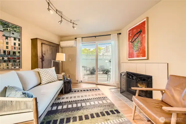 Large living room with AC , cozy fireplace and walk out patio