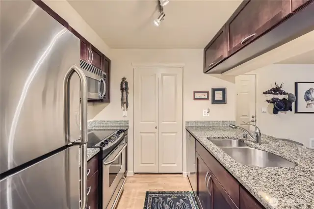 Open concept kitchen. High end Miele, dishwasher, granite countertops, lots of storage with two pantries,