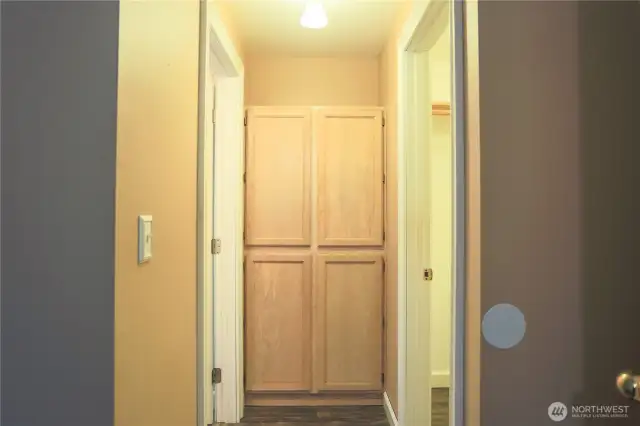 Primary bedroom access to bathroom and walk in closet, and built in cabinets/storage.