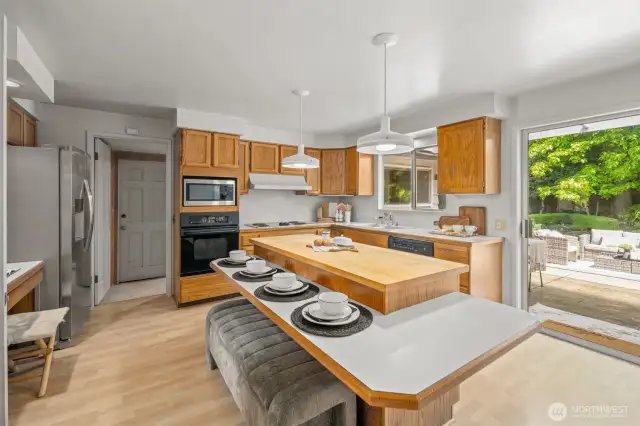 Sliding door leads to wide patio and backyard