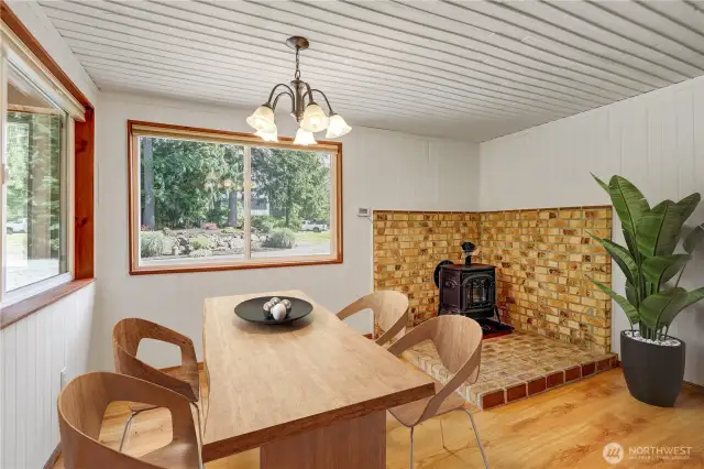 Dining Room with Cozy Propane Gas Stove  Virtually staged