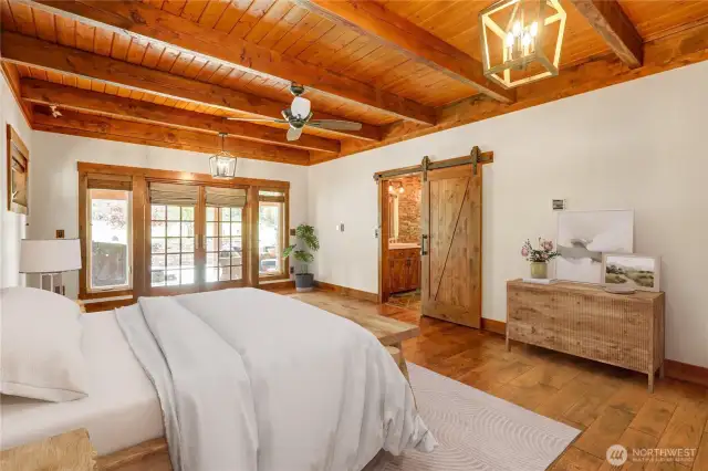 Huge Master Bedroom with Barn Doors, Hardwood Flooring and Wood Plank Ceiling