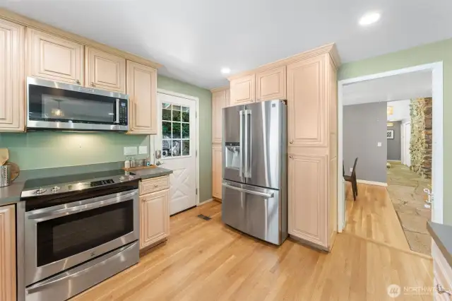 A thoughtful layout connects the kitchen to the main hallway and dining room, offering a seamless flow for cooking, entertaining, and everyday gathering. Beautiful crown molding and cabinetry adds an elegant touch to this inviting space.