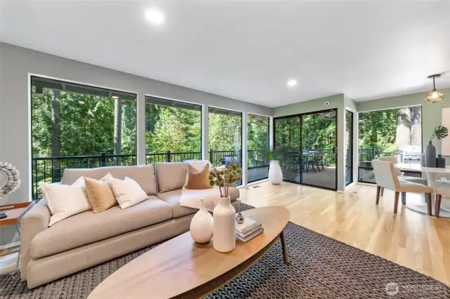 Refinished hardwood floors in 2025 add warmth and elegance to this light-filled secondary living room, and flows seamlessly from the breakfast nook to the kitchen.
