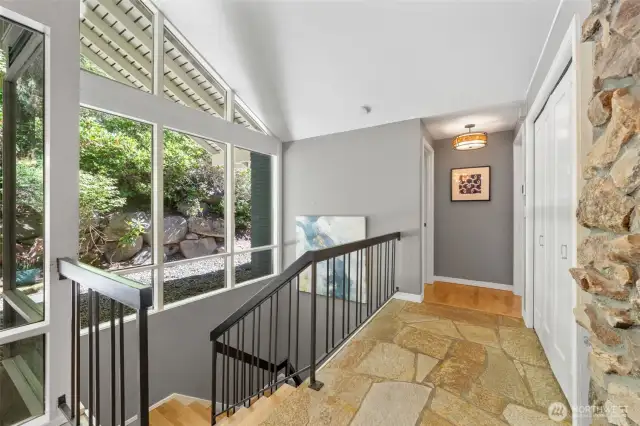 Just off the entry, this sunlit hallway offers additional closet storage and leads to the powder room and the tranquil Primary Suite.