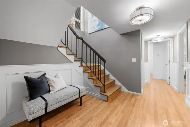 In the opposite direction, the hallway leads to a full bath and additional bedrooms, all showcasing stylish finishes and a layout thoughtfully designed for guest or family comfort. Don’t miss the hidden nook tucked under the stairs—a charming and functional surprise!