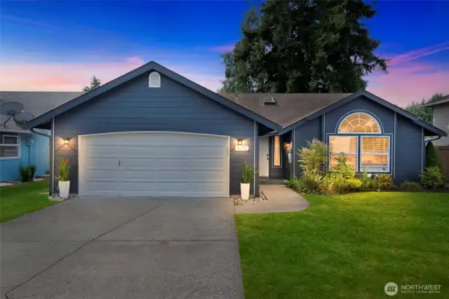 Twilight glow highlights this inviting rambler in the desirable Lakepointe neighborhood with great curb appeal and a welcoming, covered front entry.