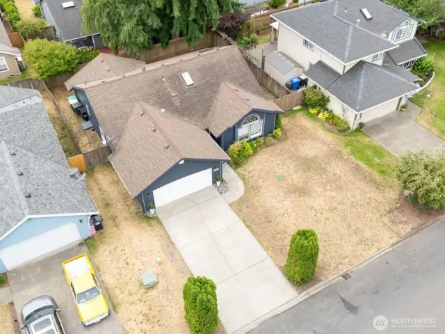 Aerial view shows off the oversized lot, fully fenced backyard, and quiet residential setting.