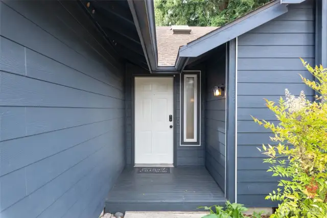 Covered front entryway provides a protected spot to greet guests or enjoy a moment of shade.