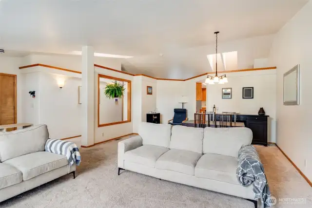 Spacious living room with bay window and open flow into the dining area and kitchen—perfect for entertaining or relaxing.