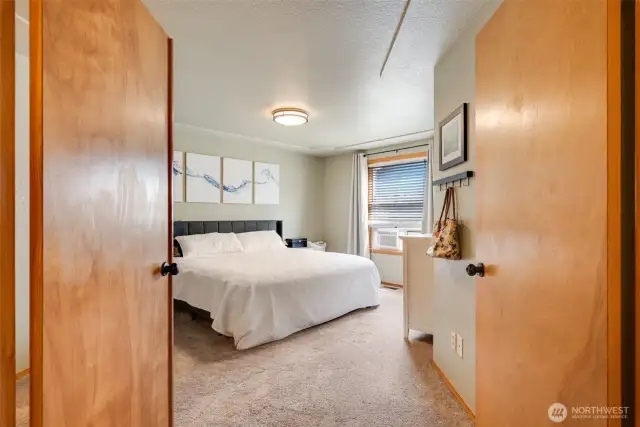 French doors open to the spacious Primary Suite with ample room for a king-size bed and cozy sitting area.