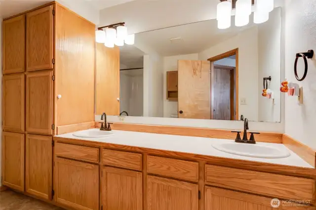 Primary bath offers extended counter & storage space, dual vanities, and a walk-in shower.