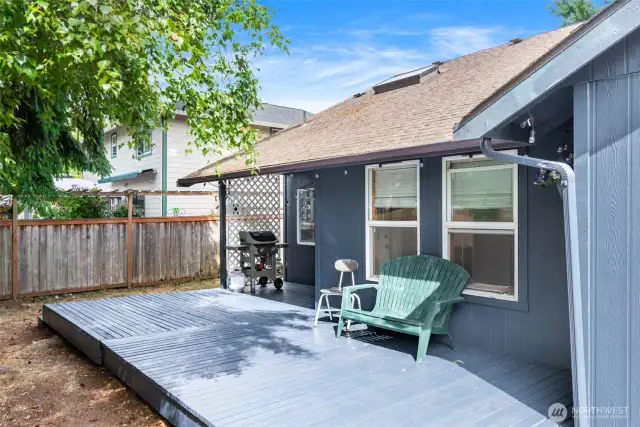 Fully fenced backyard with roomy deck and space to relax, play, or garden.