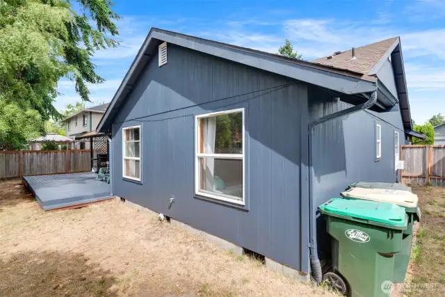 Back of the home features fresh paint, fenced yard, and access to the bonus/flex space.