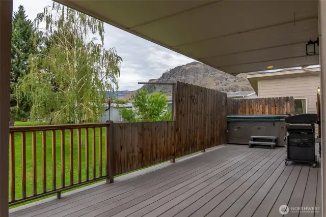 Hot tub and grilling area on the upper deck outside of kitchen sliding door