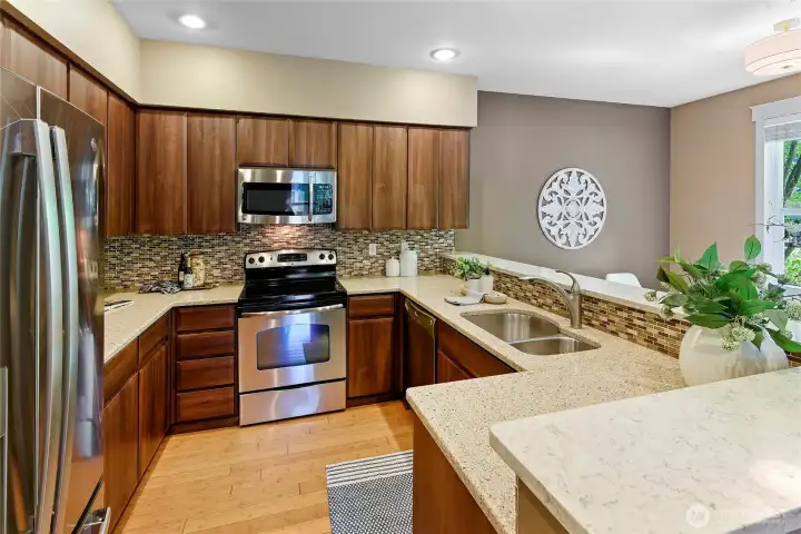 Updated kitchen with quartz countertops and stainless appliances