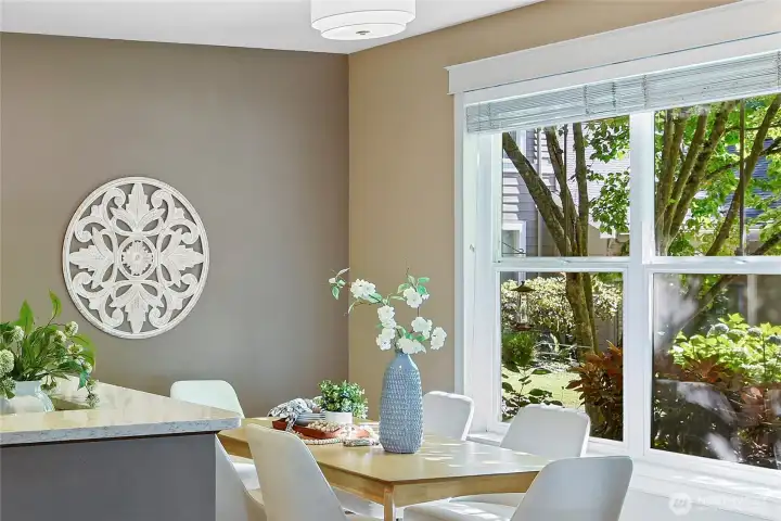 Dining room window overlooks garden-like common area