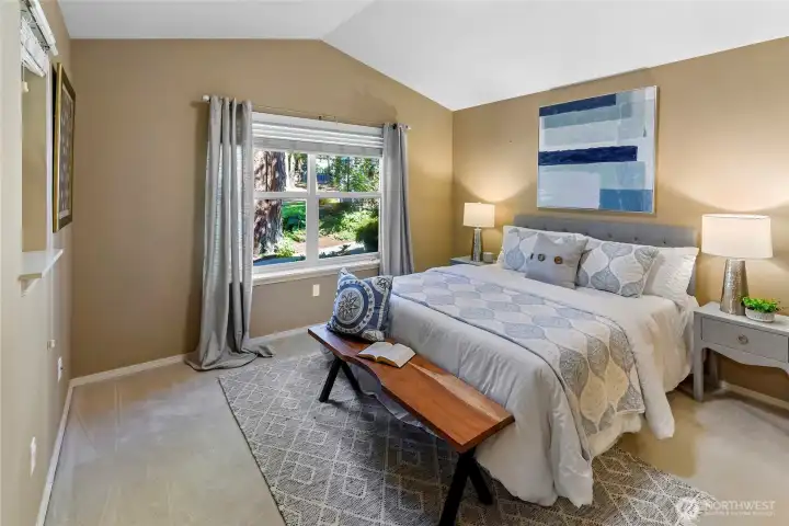 Main floor primary bedroom with vaulted ceiling