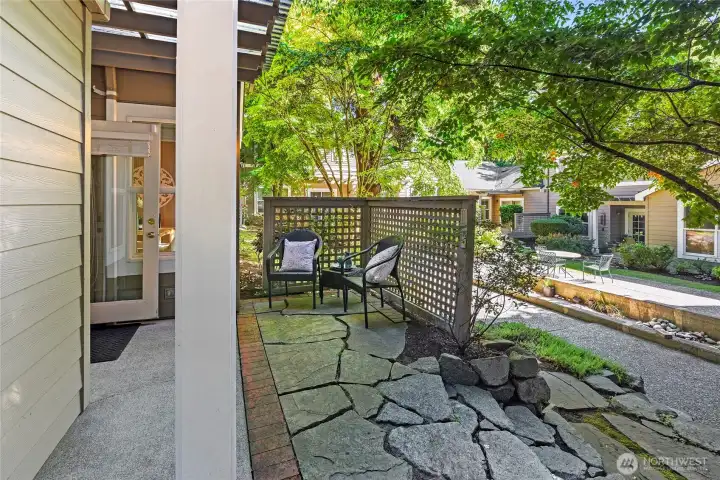 Patio off the living room and steps to the common area