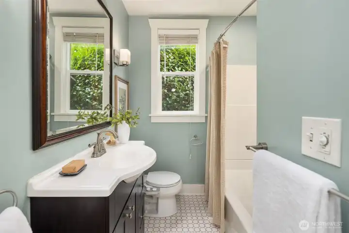 Remodeled bathroom with tile floor.