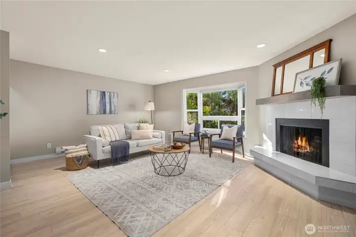 Bright and large living room with wood burning fireplace.