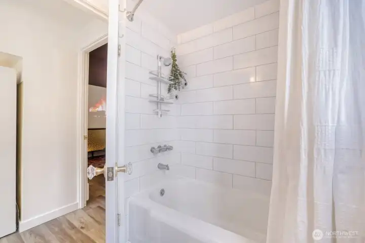 Full tub with subway tiles.