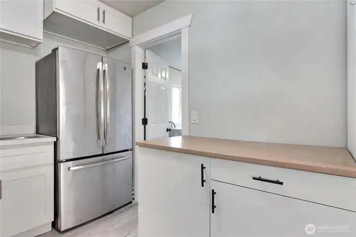 Kitchen detail showcasing extended counter space, additional cabinetry, and functional prep area.