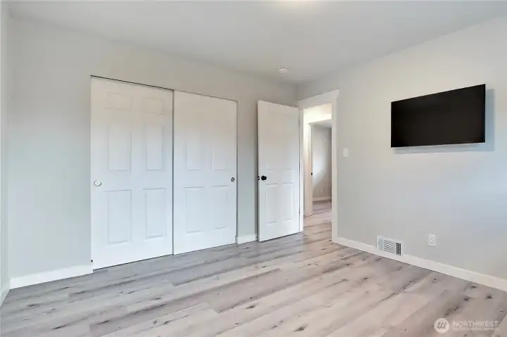 Primary bedroom with generous closet storage and flexible layout.