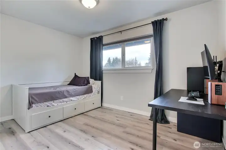 Third bedroom with updated flooring and flexible space for guest room, office, or hobby room.