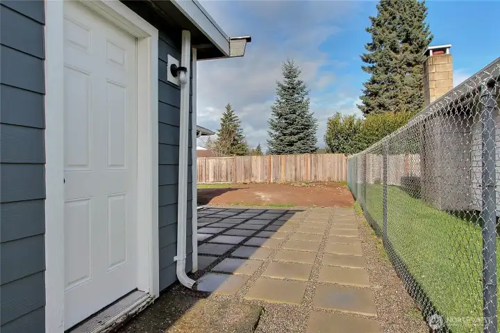 Exterior access from utility room leading to patio and backyard.
