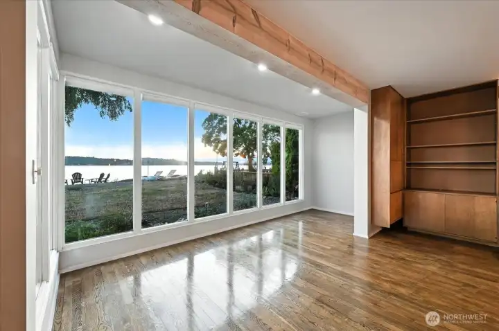 Expansive living room with floor to ceiling windows.