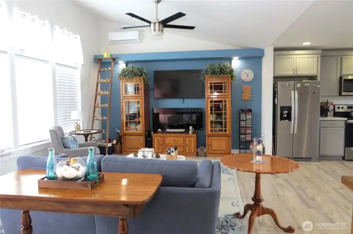 This home is beautifully designed as a cozy open concept retreat, featuring high vaulted ceilings, luxury vinyl plank flooring and premium finishes.