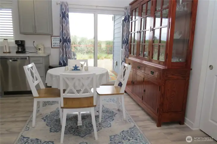 Dining room has sliding doors to the generous covered deck where you can unwind and enjoy the coastal breeze!