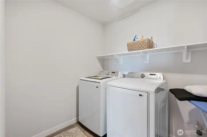 Convenient laundry area upstairs with additional storage space