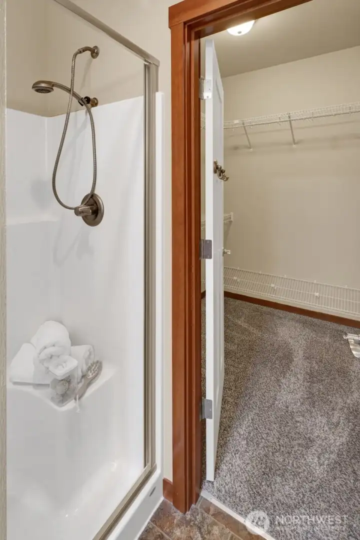 A large walk in shower & private water closet.