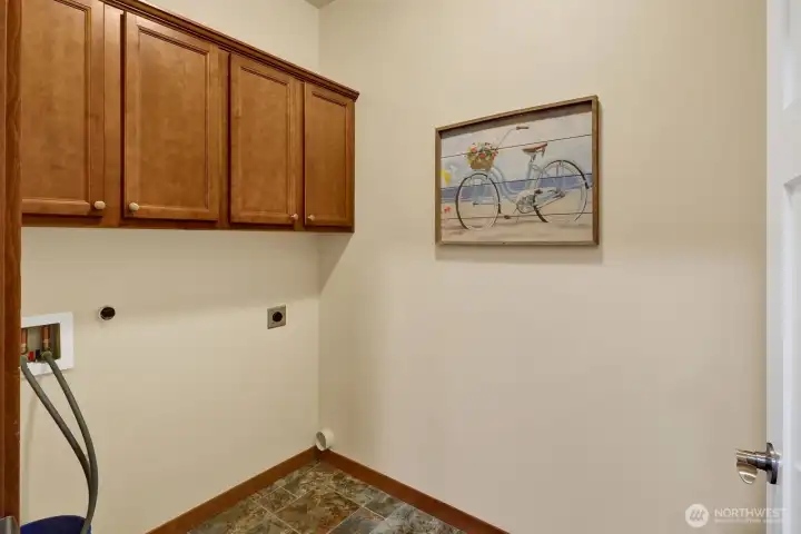 The laundry room is located next to the kitchen and primary suite.