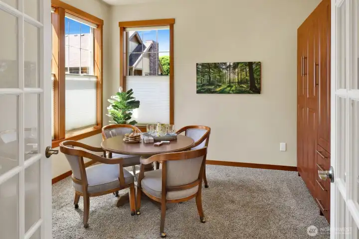 A flexible bedroom with French doors and a Murphy bed adapts effortlessly to guests, hobbies, or a home office.