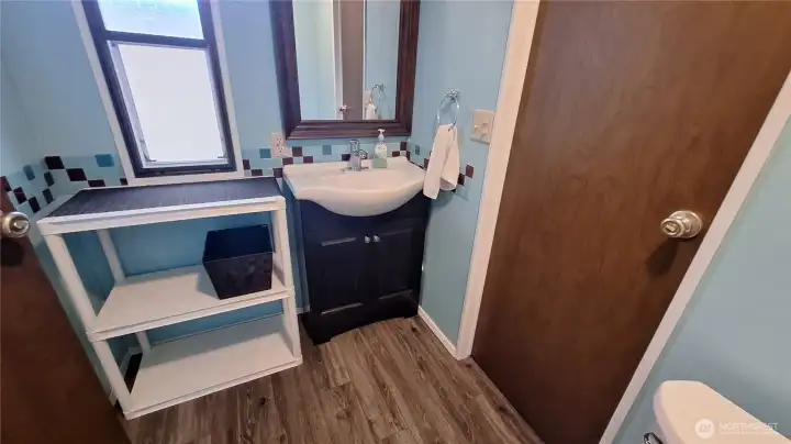 BATHROOM OFF THE UTILITY RM AND DOOR INTO THE 2ND BEDROOM.