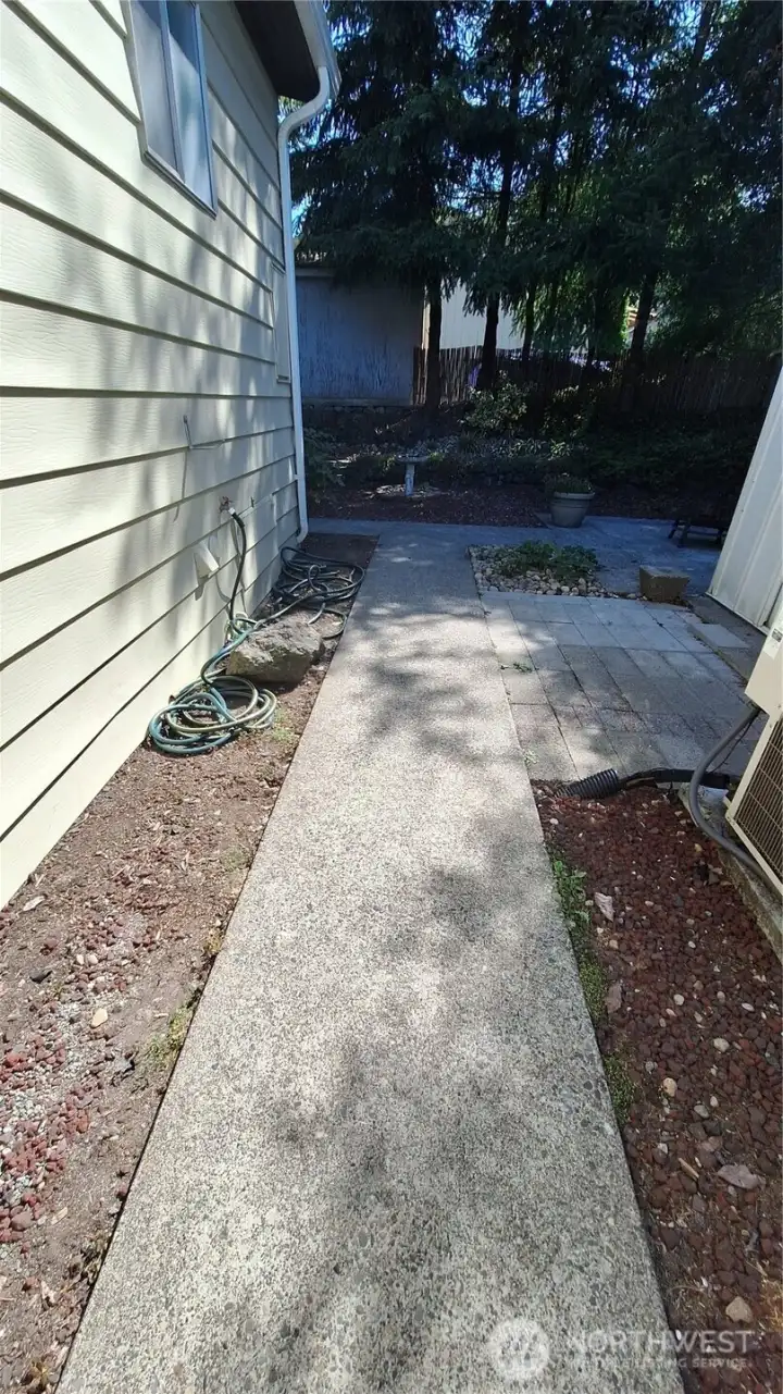 NICE CONCRETE WALKWAYS AROUND IN TO THE BACK YARD.