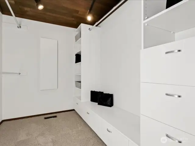 An extra-large walk-in closet, complemented by additional closet space in the main bath area, provides ample storage.