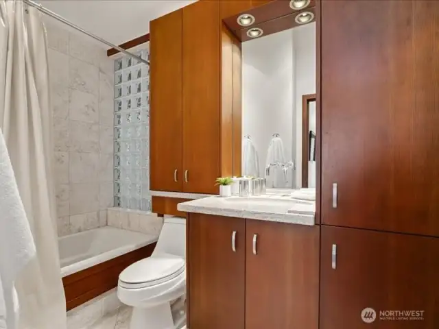 The hall bath, featuring a deep bathtub, is conveniently adjacent to the second and third bedrooms.