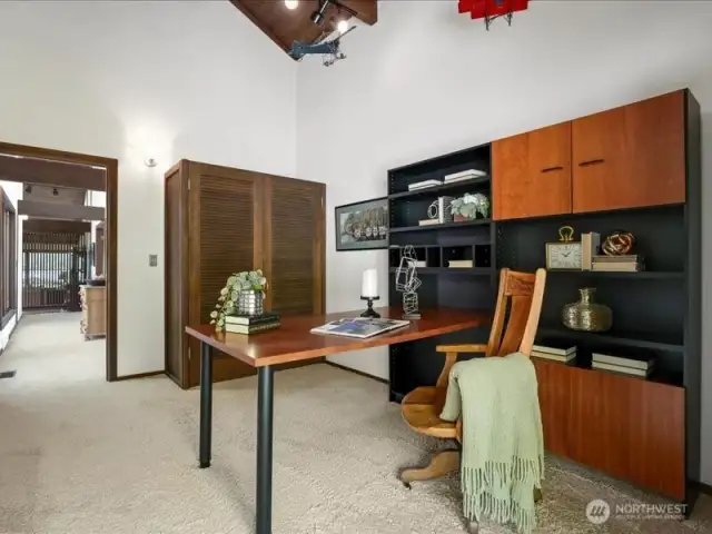 The third bedroom is currently staged as a functional home office space. Complete with closet and garden views.