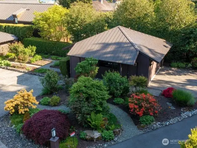 Abundant perennial and vegetable gardens enjoy all day sun and provide fresh ingredients for your kitchen and stunning blooms for your centerpieces. The structure is the detached garage...ready for your vision as a guest house, or ultra cool man cave or she-shed! Additional parking here as well.