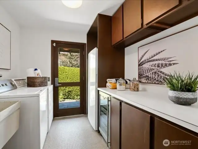 The large laundry room offers outside entrance, extra storage and freezer.