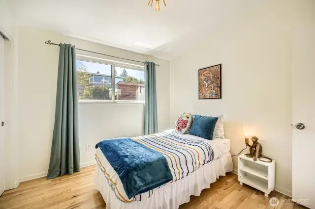 2nd bedroom looks out to  lush backyard