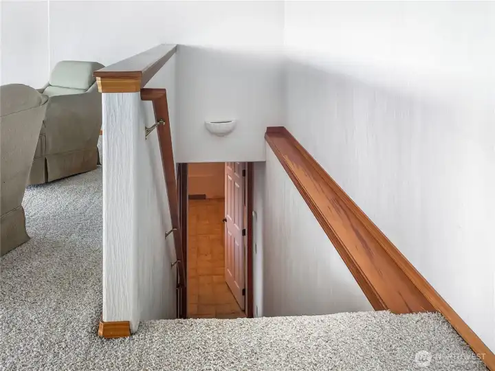 Going downstairs to two rooms. Room with furnace and closet and central vac. And room with Hot tub.